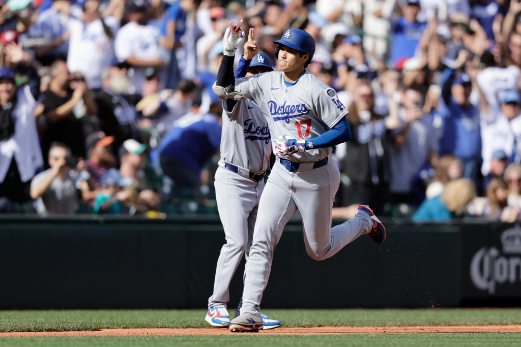 Los Angeles Dodgers' Shohei Ohtani rounds the bases on his solo home run off Seattle Mariners pitcher Caleb Ferguson during the seventh inning of a baseball game Sunday, Sept. 28, 2025, in Seattle. (AP Photo/John Froschauer)
