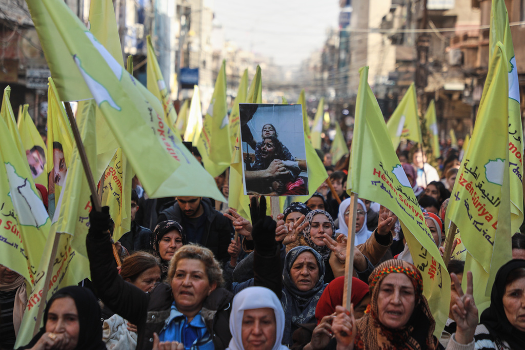 Demonstrators chant slogans in support of the Kurdish-led Syrian Democratic Forces (SDF) during a protest in Qamishli, northeastern Syria, Thursday, Jan. 8, 2026. (AP Photo/Hogir Al Abdo)