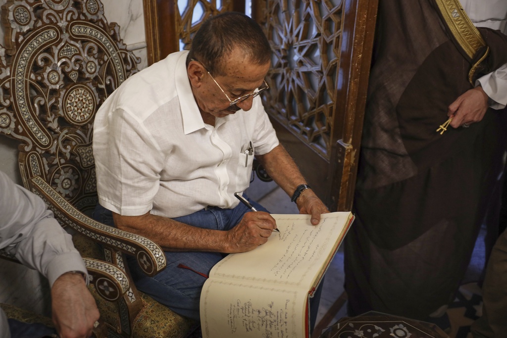 Emirati business magnate Khalaf al-Habtoor, chairman of the Al Habtoor Group, signs the visitors book during a visit to the Umayyad Mosque as part of a delegation trip to explore investment opportunities in Syria, in the Old City of Damascus, Tuesday, Sept. 9, 2025.(AP Photo/Omar Albam)