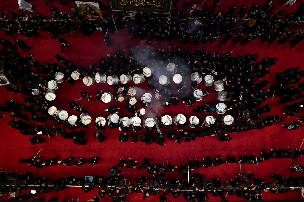 Shiites participate in Muharram processions of the Imam Ali shrine in Najaf, Iraq, Sunday, June 21, 2026, to mark the death of Hussein, the grandson of the Prophet Muhammad in present-day Iraq in the 7th century. (AP Photo/Anmar Khalil)
