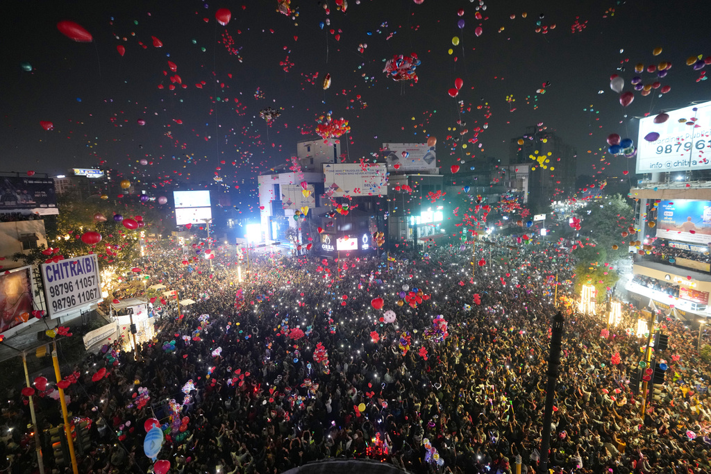 People release balloons as they gather to celebrate the New Year in Ahmedabad, India, Thursday, Jan. 1, 2026. (AP Photo/Ajit Solanki)