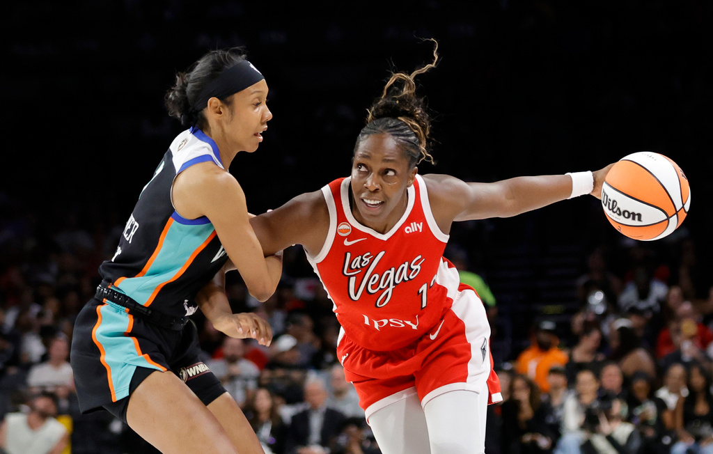 Las Vegas Aces guard Chelsea Gray (12) drives against New York Liberty guard Rebekah Gardner (7) during the first half of an WNBA basketball game Thursday, July 30, 2026, in Las Vegas. (Steve Marcus/Las Vegas Sun via AP)