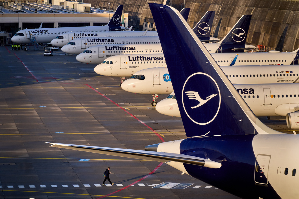 FILE - A man walks past parked Lufthansa aircraft at the airport as Lufthansa pilots are on a two-day strike, in Frankfurt, Germany, Thursday, March 12, 2026. (AP Photo/Michael Probst, File)