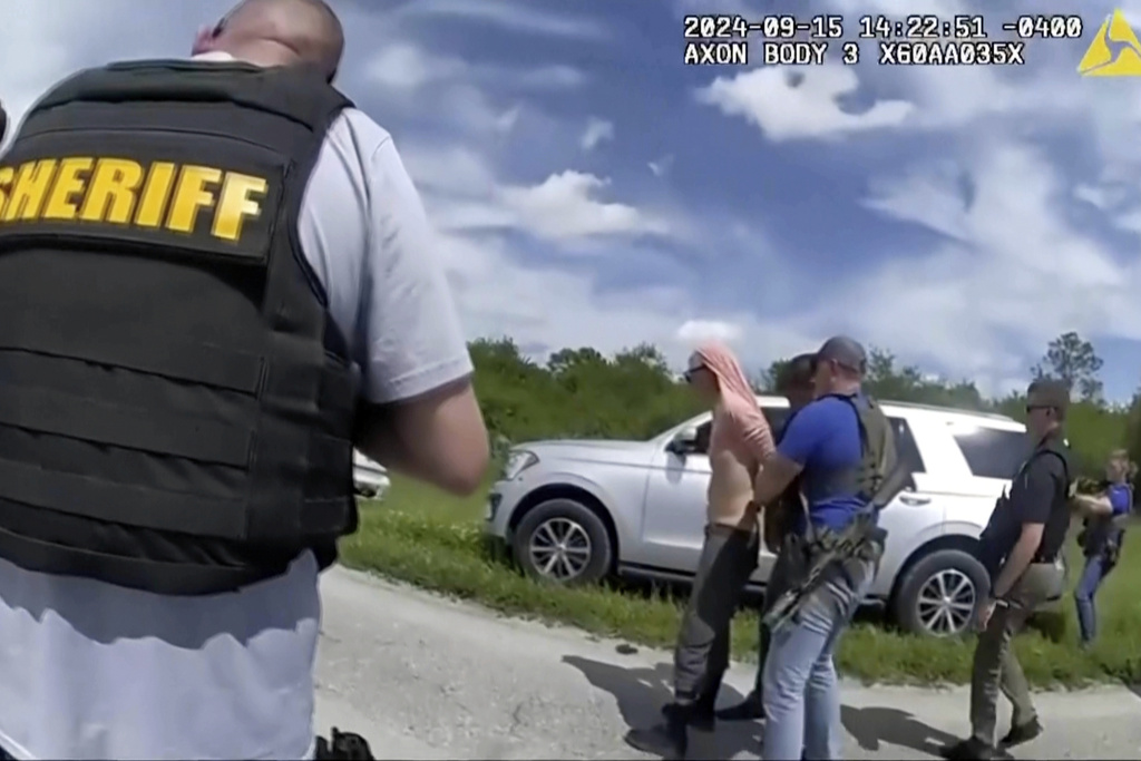 FILE - In this image taken from police body camera video and released by the Martin County, Fla., Sheriff's Office, law enforcement officers arrest Ryan Routh, the man suspected in the apparent assassination attempt of Donald Trump, Sept. 15, 2024. (Martin County Sheriff's Office via AP, File)