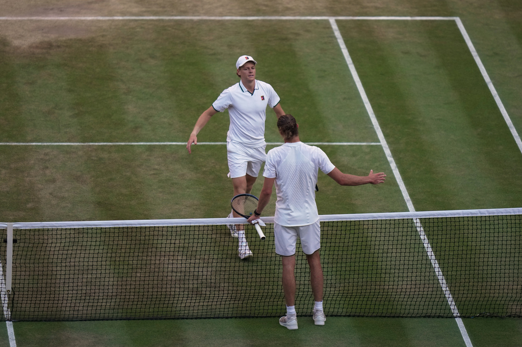 Jannik Sinner of Italy, top, and Alexander Zverev of Germany greet each other at the end of their men's singles final at Wimbledon Tennis Championships in London, Sunday, July 12, 2026. (AP Photo/Brian Inganga)