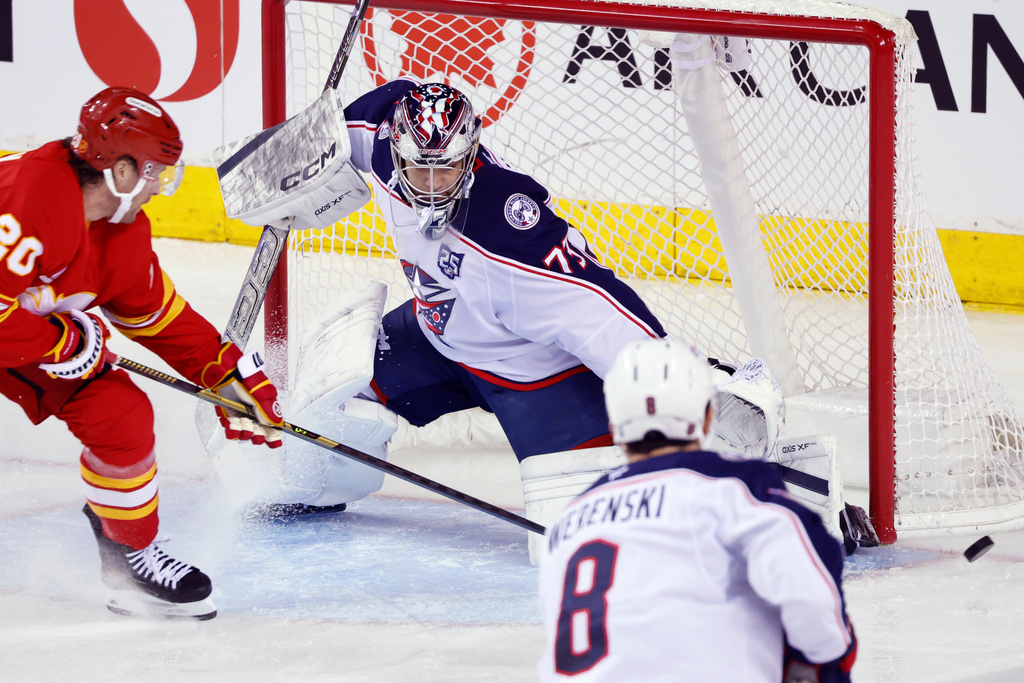 Columbus Blue Jackets goalie Jet Greaves makes a save against Calgary Flames' Blake Coleman during second period NHL hockey action in Calgary on Wednesday, Nov. 5, 2025. (Larry MacDougal/The Canadian Press via AP)