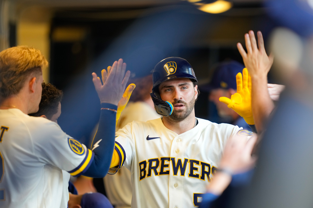 Milwaukee Brewers' Garrett Mitchell high-fives teammates after scoring on an RBI single hit by Andrew Vaughn during the sixth inning of a baseball game against the Pittsburgh Pirates Thursday, Aug. 6, 2026, in Milwaukee. (AP Photo/Kayla Wolf)