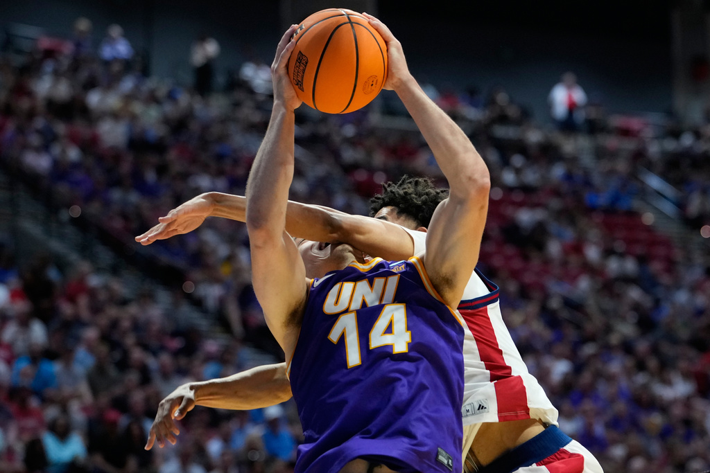 Northern Iowa forward Tristan Smith (14) is hit by St. John's guard Oziyah Sellers during the first half in the first round of the NCAA college basketball tournament Friday, March 20, 2026, in San Diego. (AP Photo/Mark J. Terrill)