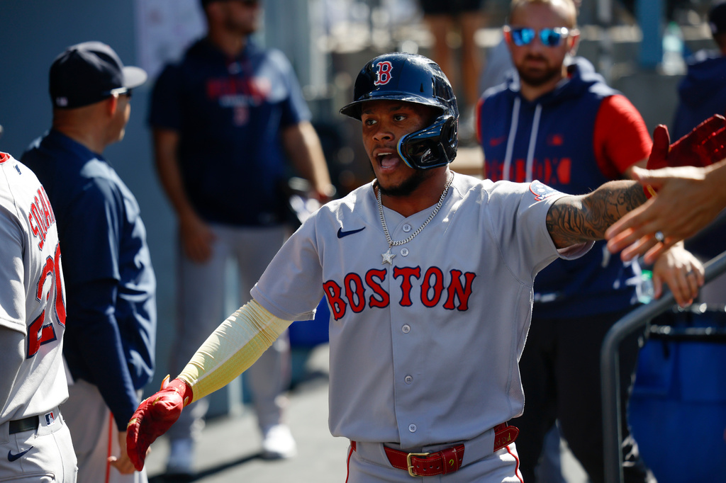 Boston Red Sox's Ceddanne Rafaela is greeted by teammates after scoring on a single hit by Sox's designated hitter Masataka Yoshida during the first inning of a baseball game, Sunday, Aug. 2, 2026, in Los Angeles. (AP Photo/Caroline Brehman)