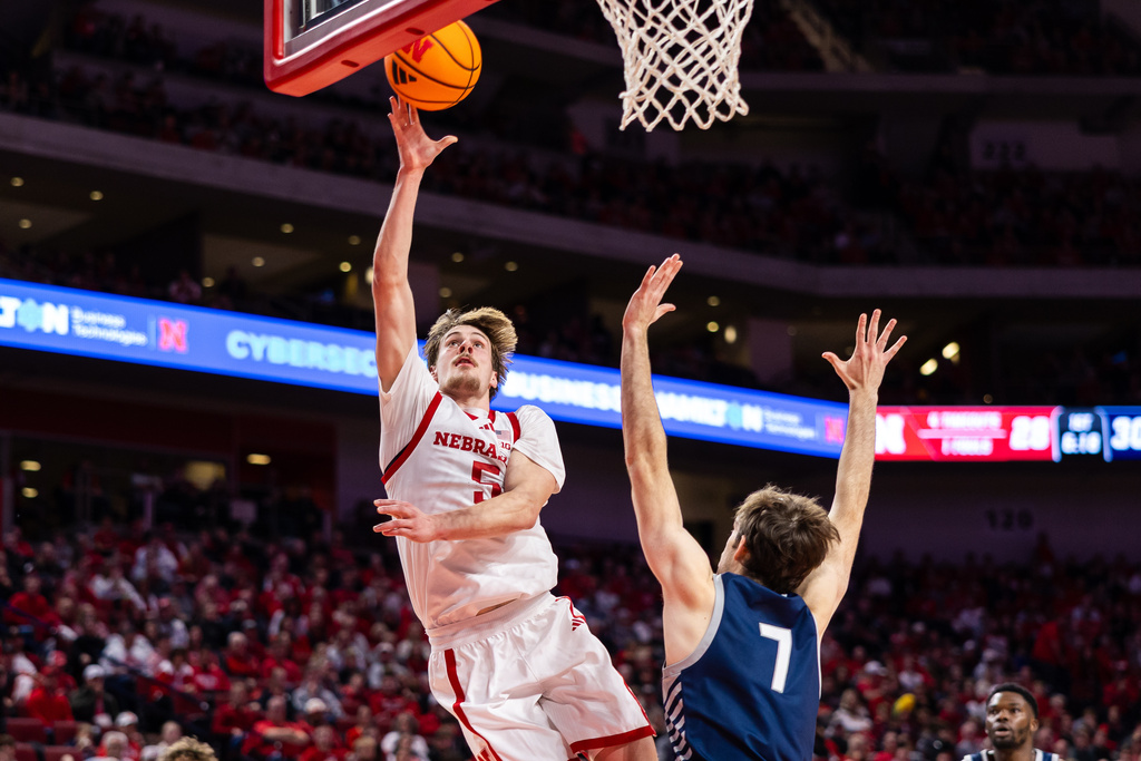 Nebraska forward Braden Frager (5) goes in for a layup against New Hampshire forward John Squire (7) during the first half of an NCAA college basketball game, Tuesday, Dec. 30, 2025, in Lincoln, Neb. (AP Photo/Bonnie Ryan)