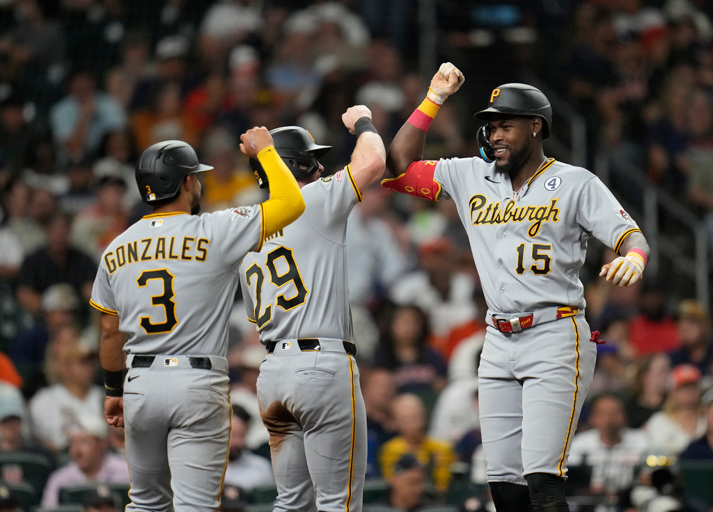 Pittsburgh Pirates' Oneil Cruz (15) celebrates his three-run home run with Ryan O'Hearn (29) and Nick Gonzales (3) against Houston Astros starting pitcher Mike Burrows during the sixth inning of a baseball game, Tuesday, June 2, 2026, in Houston. (AP Photo/Karen Warren)