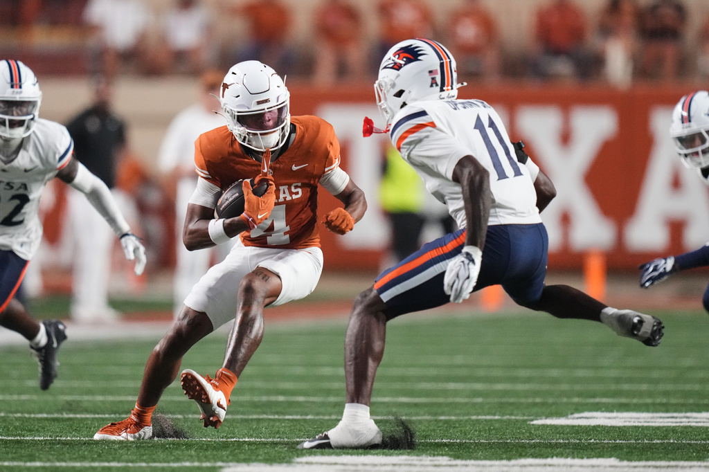 Texas wide receiver Jermaine Bishop Jr. (4) catches a pass for a first down as UTSA safety Cameron Upshaw Jr. (11) moves in to make the stop during the first half of an NCAA college football game in Austin, Texas, Saturday, Sept. 19, 2026. (AP Photo/Eric Gay)