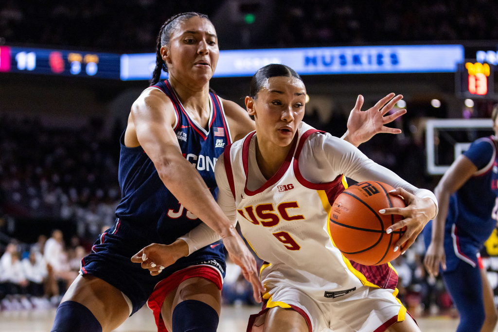 Southern California guard Jazzy Davidson (9) is defended by UConn guard Azzi Fudd (35) during the first half of an NCAA college basketball game Saturday, Dec. 13, 2025, in Los Angeles. (AP Photo/Ethan Swope)