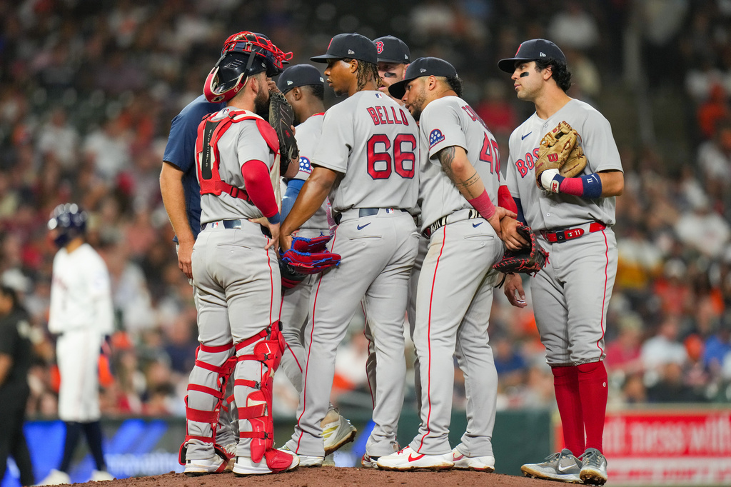 Boston Red Sox starting pitcher Brayan Bello (66) talks with teammates during a mound visit in the fifth inning of a baseball game against the Houston Astros in Houston, Tuesday, March 31, 2026. (AP Photo/Jon Shapley)