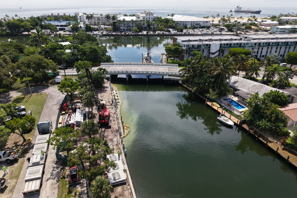 Workers install a 3D-printed living seawall manufactured by Kind Designs at the Church by the Sea, Tuesday, Aug. 4, 2026, in Fort Lauderdale, Fla. (AP Photo/Daniel Kozin) CORRECTS: byline to Daniel Kozin from Lynne Sladky