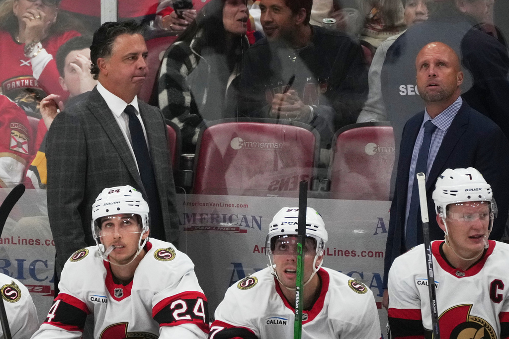 Ottawa Senators center Dylan Cozens (24) and left wing David Perron (57) look up at the scoreboard during the third period of an NHL hockey game against the Florida Panthers, Saturday, Oct. 11, 2025, in Sunrise, Fla. (AP Photo/Marta Lavandier)