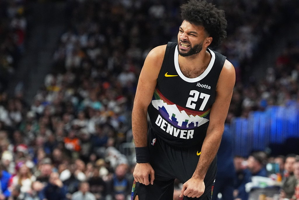 Denver Nuggets guard Jamal Murray grimaces after losing control of the ball in the first half of an NBA basketball game against the Minnesota Timberwolves, Thursday, Dec. 25, 2025, in Denver. (AP Photo/David Zalubowski)