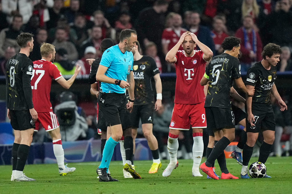 Bayern's Harry Kane, center, reacts to a call by referee Joao Pinheiro during the Champions League semifinal second leg soccer match between Bayern Munich and Paris Saint Germain in Munich, Germany, Wednesday, May 6, 2026. (AP Photo/Matthias Schrader)