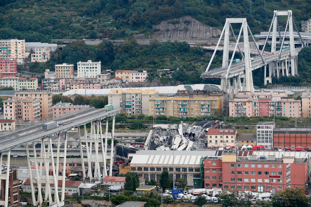 FILE - Cars are blocked on the Morandi highway bridge after a section of it collapsed, Aug. 14, 2018, in Genoa, northern Italy. (AP Photo/Antonio Calanni, File)