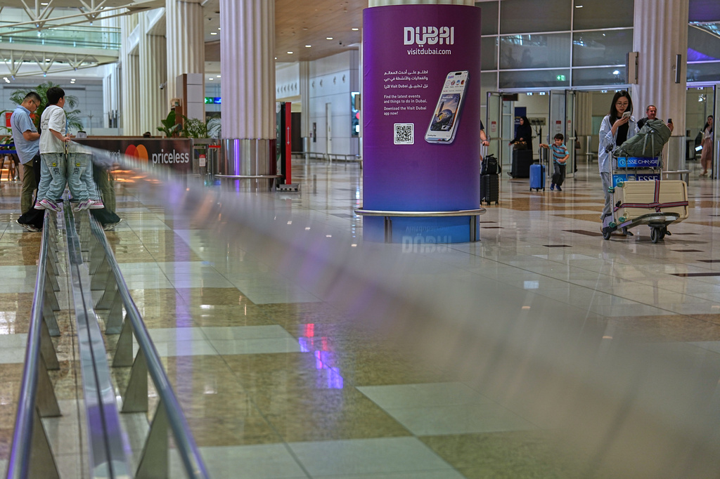 Passengers leave the baggage claim hall at Terminal 3 of Dubai International Airport in Dubai, United Arab Emirates, Wednesday, Aug. 26, 2026. (AP Photo/ Fatima Shbair)