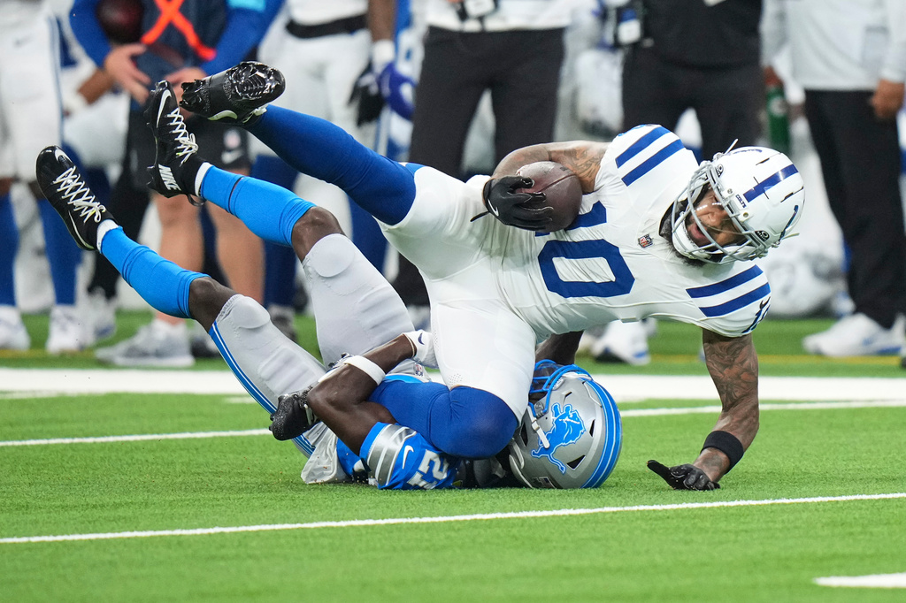 Indianapolis Colts wide receiver Keenan Allen (10) is tackled by Detroit Lions cornerback Roger McCreary (21) during the first half of a preseason NFL football game in Indianapolis, Saturday, Aug. 29, 2026. (AP Photo/AJ Mast)