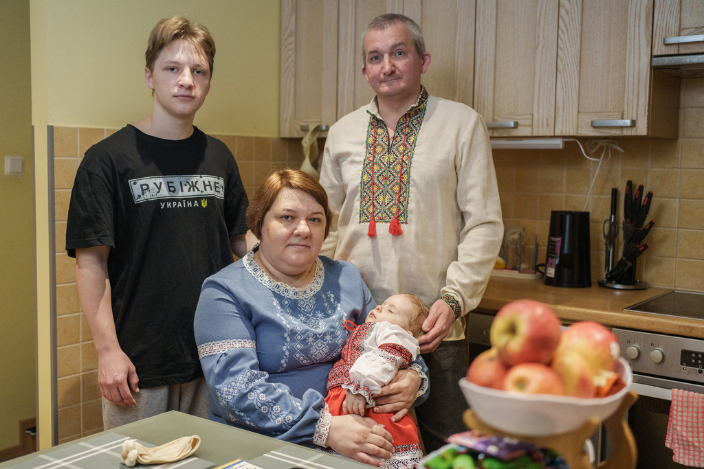 Oleksii Vnukov, right, his wife, Inna Vnukova, center left, and their children Evhen, left, and Alisa, pose during an interview with The Associated Press in their apartment in Tallinn, Estonia, Tuesday, Feb. 17, 2026. (AP Photo)