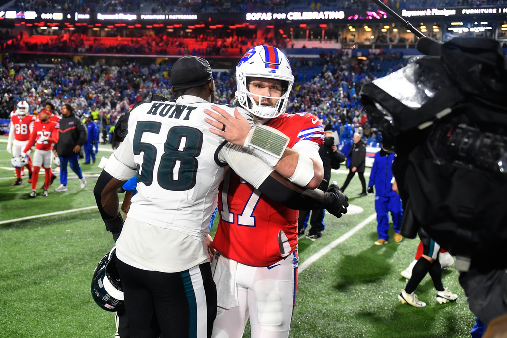 Buffalo Bills' Josh Allen, right, and Philadelphia Eagles' Jalyx Hunt meet after an NFL football game, Sunday, Dec. 28, 2025, in Buffalo, N.Y. (AP Photo/Adrian Kraus)
