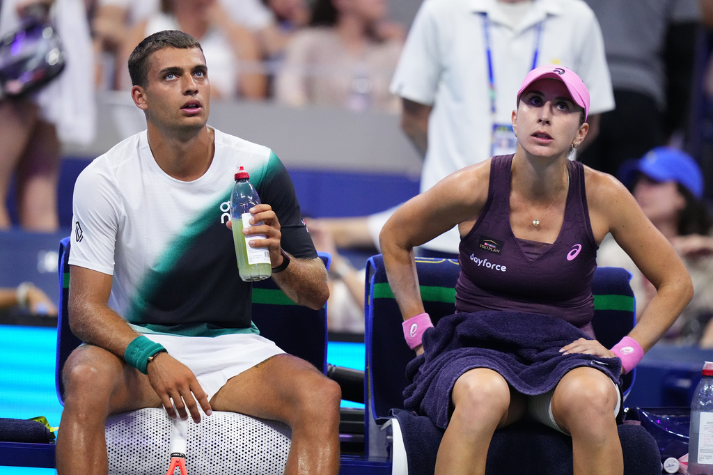 Belinda Bencic, right, of Switzerland, and Flavio Cobolli, of Italy, sit between sets while competing against Jakub Mensik, of the Czech Republic, and Karolina Muchova, of the Czech Republic, during the mixed doubles final match at the U.S. Open tennis championships Wednesday, Aug. 26, 2026, in New York. (AP Photo/Frank Franklin II)