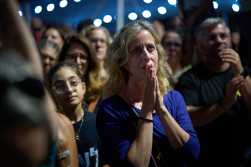 People gather to celebrate following the announcement that Israel and Hamas have agreed to the first phase of a peace plan to pause the fighting, at a plaza known as Hostages Square in Tel Aviv, Israel, Thursday, Oct. 9, 2025. (AP Photo/Emilio Morenatti)