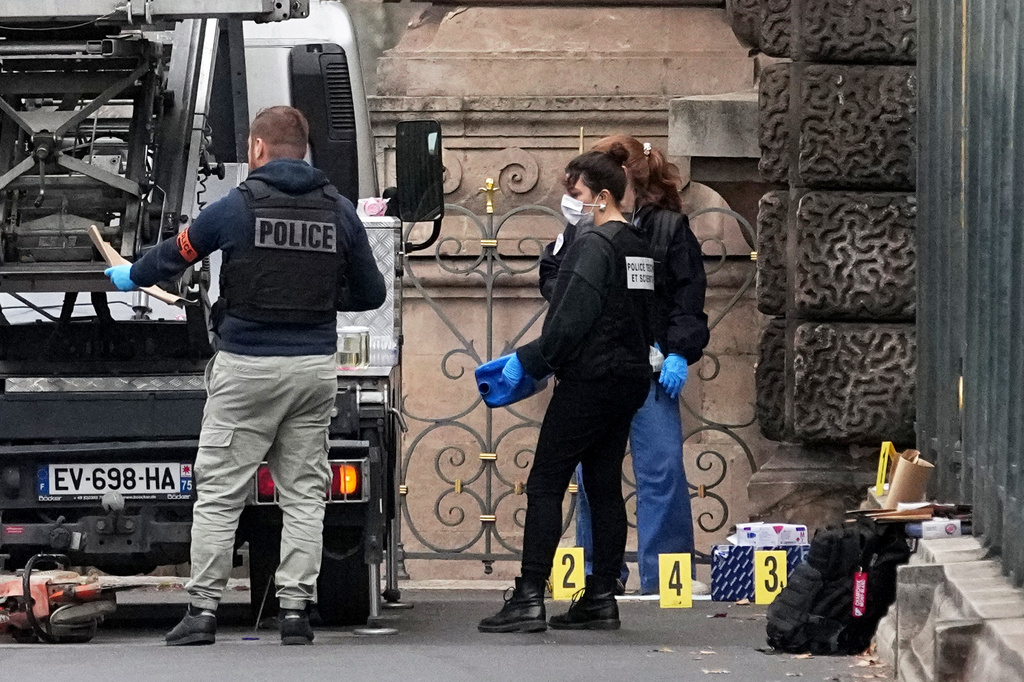 Police officers look for clues by a basket lift used by thieves Sunday, Oct. 19, 2025 at the Louvre museum in Paris. (AP Photo/Thibault Camus)