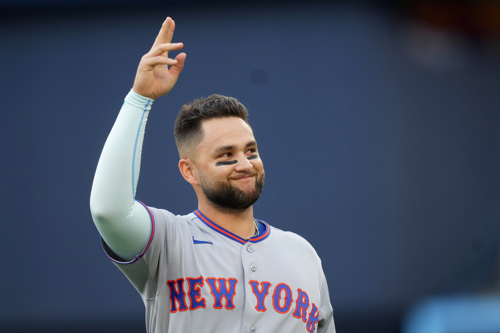 New York Mets third baseman Bo Bichette acknowledges the crowd as he is presented with a tribute video from his time on the Toronto Blue Jays prior to a baseball game between the Mets and the Blue Jays in Toronto, Monday, June 29, 2026. (Nathan Denette/The Canadian Press via AP)