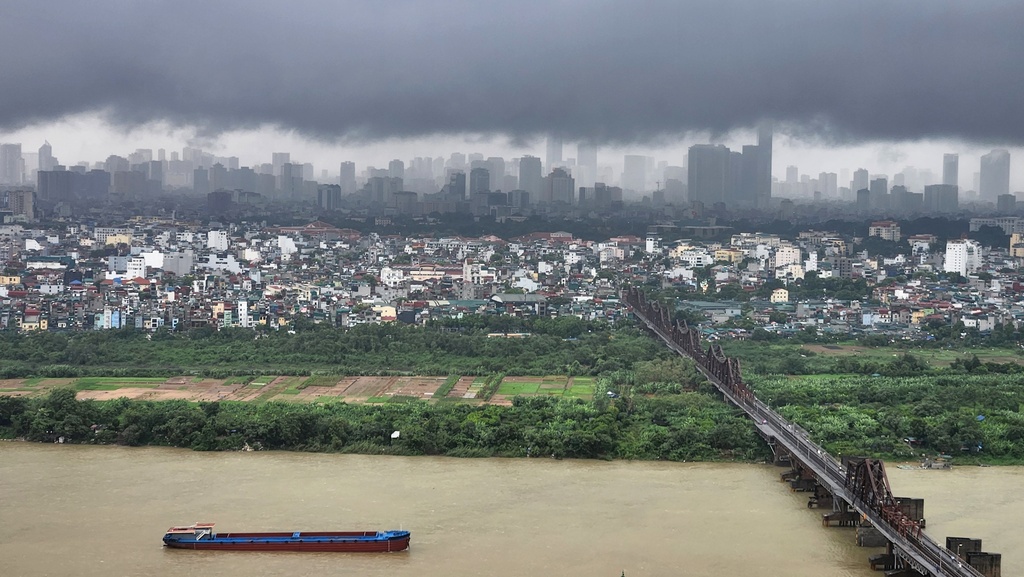 Dark clouds hang over the Hanoi skyline and the Red River after Typhoon Bualoi swept across the country, in Hanoi, Vietnam, Monday, Sept. 29, 2025. (AP Photo/Dan Dockery)