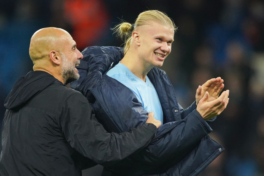 Manchester City's head coach Pep Guardiola, left, celebrates with Erling Haaland after the English Premier League soccer match between Manchester City and Bournemouth in Manchester, England, Sunday, Nov. 2, 2025. (AP Photo/Ian Hodgson)