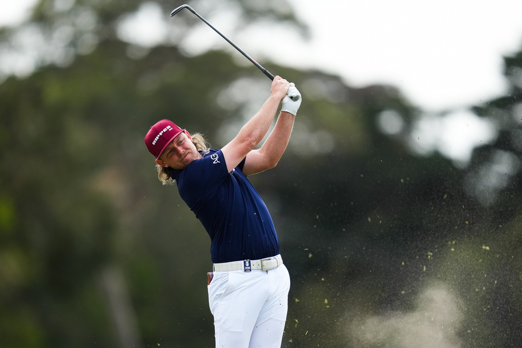 Cam Smith of Australia plays an approach shot on the 18th Hole during the first round of the Australian Open golf tournament in Melbourne, Australia, Thursday, Dec. 4, 2025. (AP Photo/Asanka Brendon Ratnayake)
