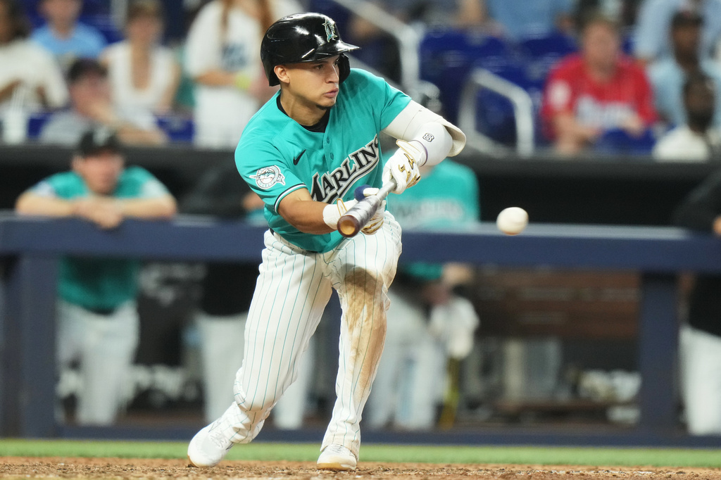 Miami Marlins' Javier Sanoja hits a sacrifice bunt during the ninth inning of a baseball game against the New York Mets, Sunday, May 24, 2026, in Miami. (AP Photo/Lynne Sladky)