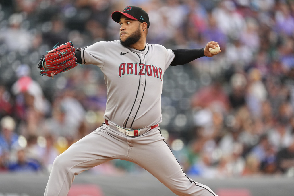 Arizona Diamondbacks starting pitcher Eduardo Rodriguez works against the Colorado Rockies in the first inning of a baseball game Thursday, Aug. 14, 2025, in Denver. (AP Photo/David Zalubowski)