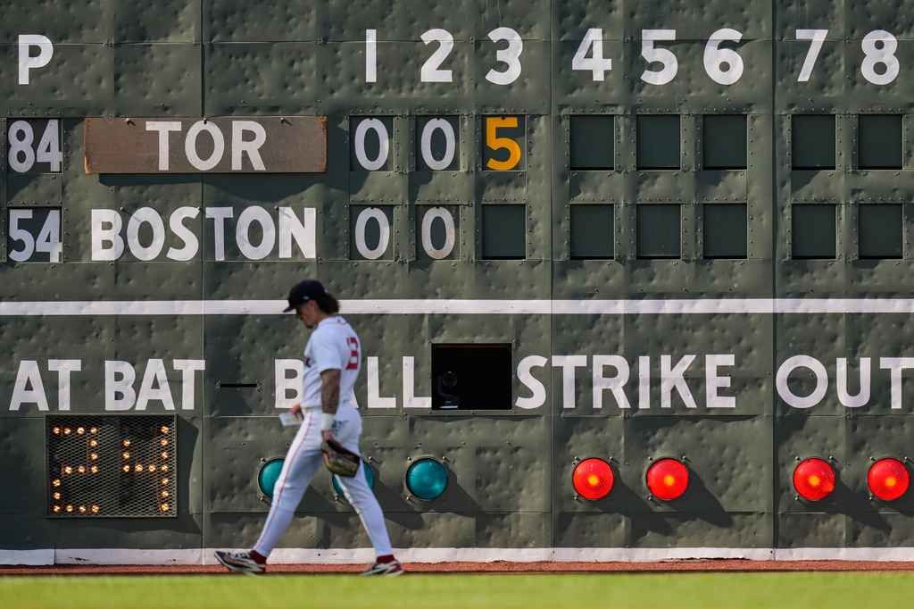 Boston Red Sox's Jarren Duran walks past the scoreboard during a rough top of the fifth inning against the Toronto Blue Jays during a baseball game, Saturday, July 25, 2026, in Boston. (AP Photo/Charles Krupa)