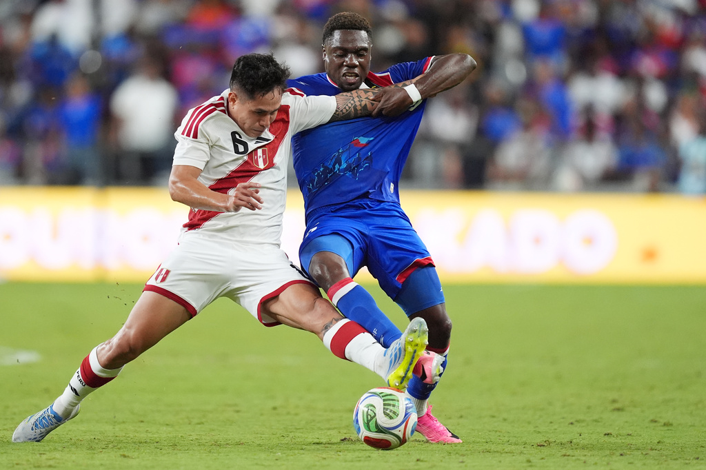 FILE - Peru midfielder Jesus Pretell (6) vies for the ball with Haiti midfielder Dominique Simon during the second half of an international friendly soccer match, Friday, June 5, 2026, in Miami. (AP Photo/Rebecca Blackwell, File)