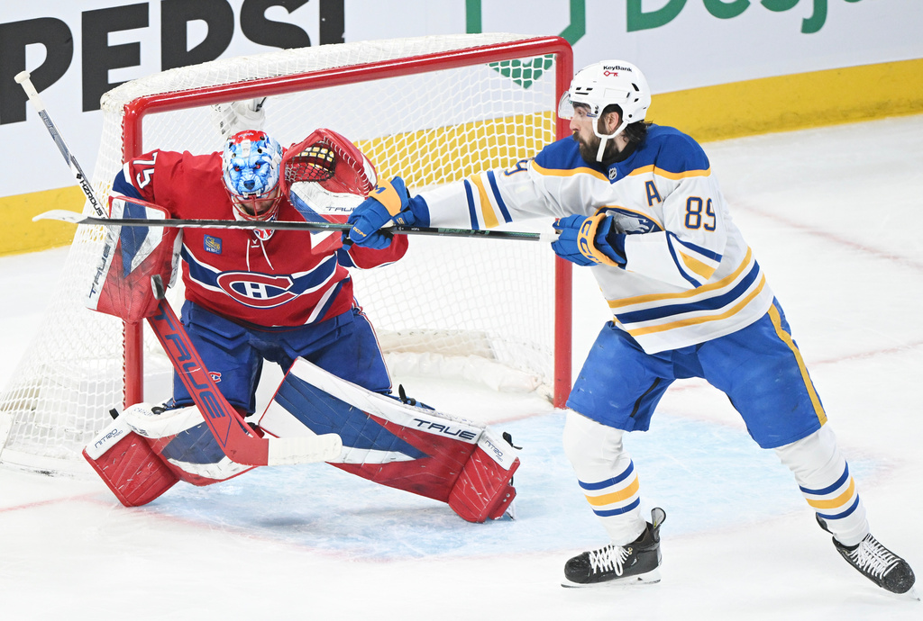 Buffalo Sabres' Alex Tuch (89) tries to tip the puck past Montreal Canadiens goaltender Jakub Dobes (75) during the first period of Game 3 in a second-round NHL hockey Stanley Cup playoff series in Montreal, Sunday, May 10, 2026. (Graham Hughes/The Canadian Press via AP)