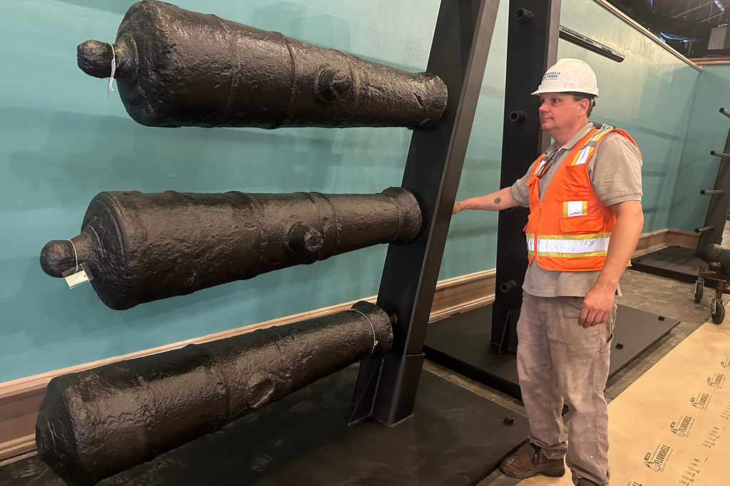Terry Koeller inspects cannons, which sunk to the bottom of the Savannah River during the American Revolution, on a rack at the Savannah History Museum in Savannah, Ga., on Wednesday, June 3, 2026. (AP Photo/Russ Bynum)