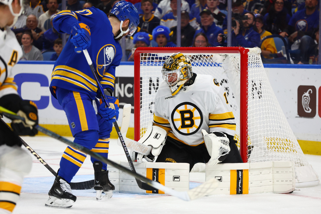Boston Bruins goaltender Jeremy Swayman (1) stops a shot by Buffalo Sabres left wing Jason Zucker (17) during the first period in Game 5 of a first-round NHL hockey Stanley Cup playoff series Tuesday, April 28, 2026, in Buffalo, N.Y. (AP Photo/Jeffrey T. Barnes)