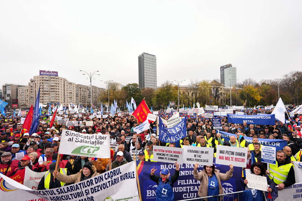Trade union members protest against the government's austerity measures, outside Victoria Palace, the government headquarters, in Bucharest, Romania, Wednesday, Nov. 12, 2025. (AP Photo/Andreea Alexandru)