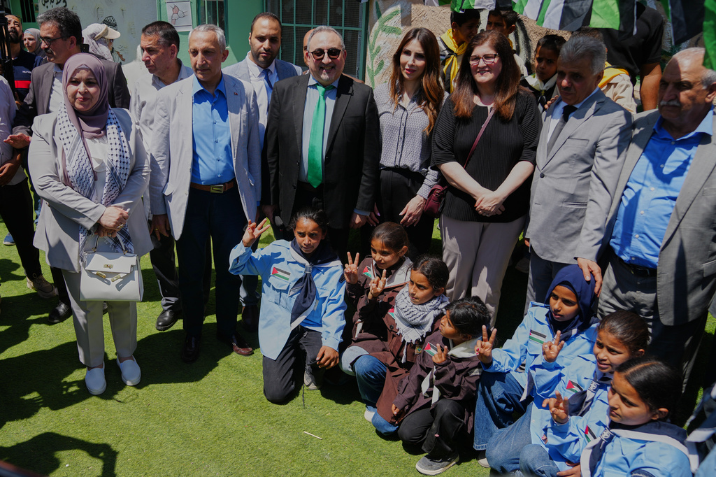 Palestinian officials and foreign diplomats take a photo with school children during their field tour in the West Bank Bedouin hamlets of Khan al-Ahmar, Wednesday, June 10, 2026. (AP Photo/Mahmoud Illean)
