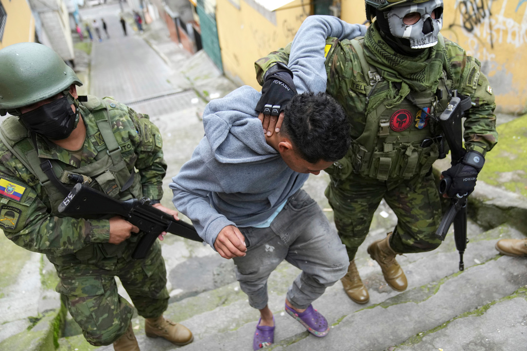 FILE - Soldiers briefly detain a youth to walk him to an area to check if he has gang-related tattoos as they patrol the south side of Quito, Ecuador, Jan. 12, 2024, in the wake of the apparent escape of a powerful gang leader from prison. (AP Photo/Dolores Ochoa, File)