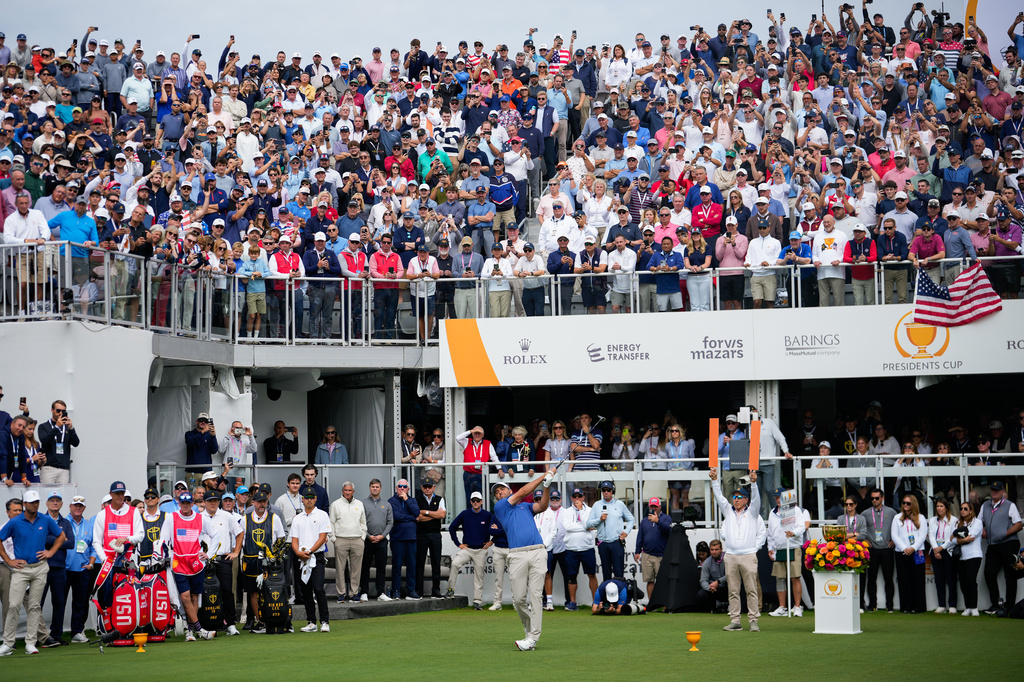 USA teams' Scottie Scheffler hits from the first tee during the first round four-ball match at the Presidents Cup golf tournament against the International team at Medinah Country Club, Thursday, Sept. 24, 2026, in Medinah, Ill. (AP Photo/Matt Slocum)