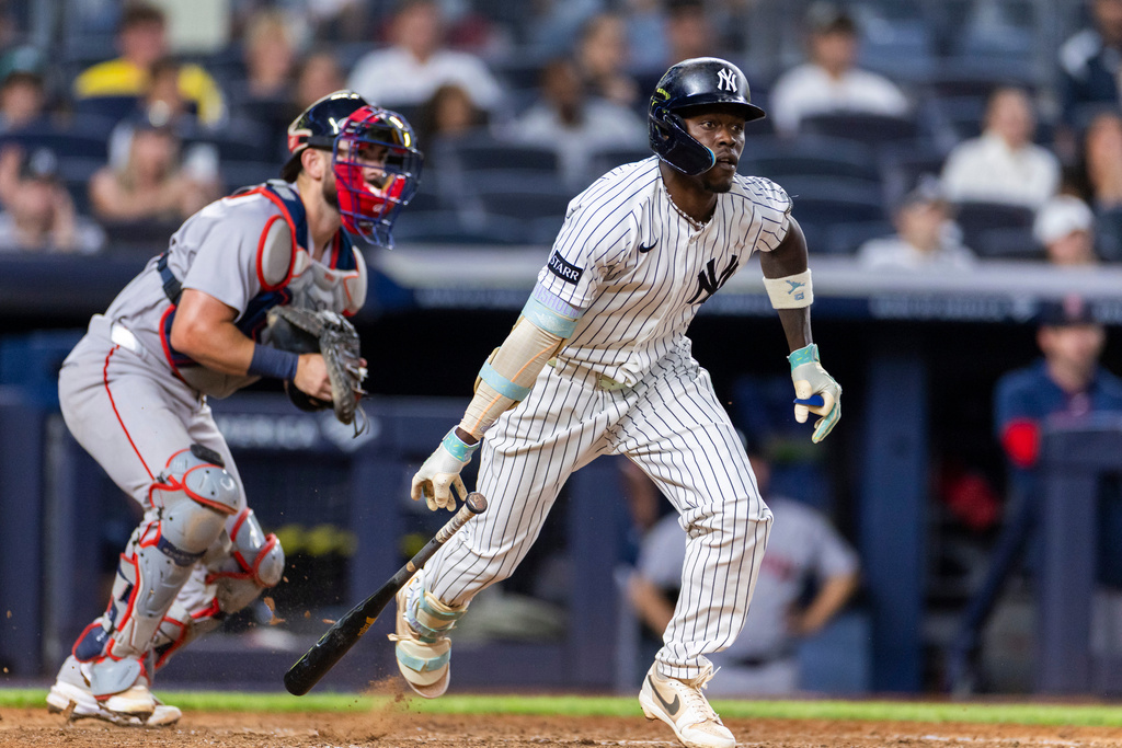New York Yankees' Jazz Chisholm Jr., right, watches after he hit into a fielder's choice in the eighth inning during the second baseball game of a doubleheader against the Boston Red Sox, Saturday, Aug. 29, 2026, in New York. (AP Photo/Corey Sipkin)