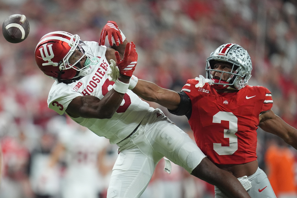 FILE - Ohio State's Lorenzo Styles Jr. breaks up a pass intended for Indiana's Omar Cooper Jr. during the first half of the Big Ten championship NCAA college football game in Indianapolis, Dec. 6, 2025. (AP Photo/Michael Conroy, File)
