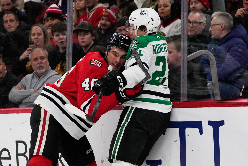 Dallas Stars left wing Jason Robertson, right, is checked by Chicago Blackhawks defenseman Louis Crevier during the first period of an NHL hockey game in Chicago, Thursday, Jan. 1, 2026. (AP Photo/Nam Y. Huh)