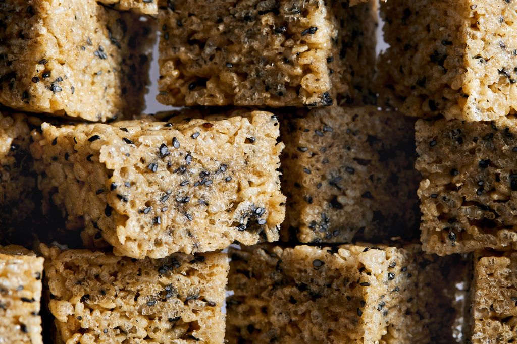 This image released by Voracious shows a recipe for black sesame and brown butter rice krispie treats from the cookbook "108 Asian Cookies" by Kat Lieu. (Charity Burggraaf/Voracious via AP)
