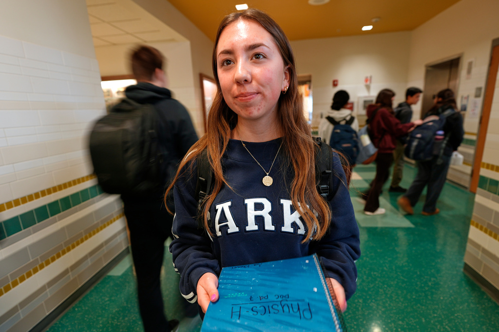 Ava Khouri, a Hanover High School senior who has trained middle school students to take initiatives to stop harmful behavior, poses in a hallway Wednesday, March 25, 2026, in Hanover, Mass. (AP Photo/Robert F. Bukaty)